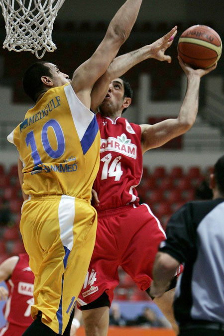Mohammad Nik (R) of Iran's Mahram goes to the basket against Ismail Ahmad of Lebanon's Al-Riyadi during their semifinal West Asian Clubs Championship basketball game in Amman March 20, 2009.